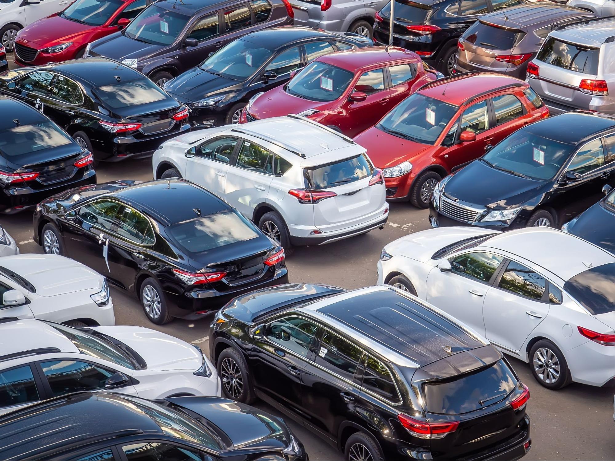 How are new cars transported to dealerships